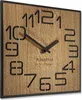 A square wooden clock with black numbers and hands. Produktbild-Vorschau