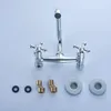 A chrome-finished faucet with two handles and a U-shaped spout, along with some accessories, is displayed against a white background. Produktbild-Vorschau