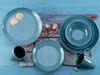 A set of blue ceramic dishes and mugs arranged on a blue wooden surface with decorative elements like shells and branches. Náhľad obrázku produktu