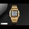 A gold digital watch is displayed on a dark, textured surface. Náhled obrázku produktu