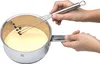 Hands whisking a yellow mixture in a silver and white pot. Anteprima dell’immagine prodotto