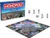 A Monopoly board game box and board with game pieces. Produktbild-Vorschau