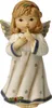 A ceramic angel figurine with wings, dressed in a white robe adorned with stars and blue trim. It has golden wings and a holly sprig on its head. The angel is holding a finger to its lips in a 'shushing' gesture. Náhled obrázku produktu