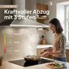 A woman is cooking in a modern kitchen with a range hood above the stove. Produktbild-Vorschau