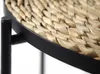 Close-up of the woven top of a round side table with a black metal frame. Produktbild-Vorschau
