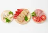Three round wooden boards are arranged horizontally, each displaying different food items. Podgląd zdjęcia produktu