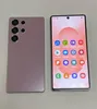 Two smartphones are displayed side-by-side on a light gray surface. The phone on the left shows its back with multiple camera lenses. The phone on the right displays its front screen with various app icons. Produktbild-Vorschau