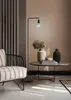 A modern living room scene with a floor lamp, armchair, and coffee table. Anteprima dell’immagine prodotto