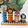 A close-up shot of a wooden stacking toy with animal figures and numbered rings. Produktbild-Vorschau