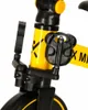 Close-up of the pedals and frame of a yellow and black tricycle. Podgląd zdjęcia produktu
