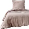 A close-up view of a beige duvet and pillow. Náhled obrázku produktu