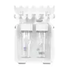 A white cosmetic device with two clear bottles on a white background. Produktbild-Vorschau
