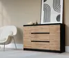 A modern living room scene featuring a sideboard, a chair, and artwork. Voir les images du produit