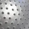 A close-up view of the textured surface of a gray exercise ball with raised bumps. Náhled obrázku produktu