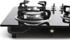 A close-up, professional studio shot of a black glass gas cooktop with silver burners and grates, set against a plain white background. Náhled obrázku produktu
