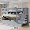 A grey bunk bed with storage and a pull-out trundle bed is shown in a bedroom setting. Produktbild-Vorschau