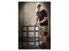 A man is working on a rolling cart in a workshop. Produktbild-Vorschau