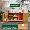 An outdoor kitchen serving cart with a stainless steel top, storage compartments, and a gas tank. It is set up on a wooden deck with plants in the background. Produktbild-Vorschau