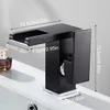 A black waterfall faucet is shown on a white sink with dimensions indicated by text overlays. Produktbild-Vorschau