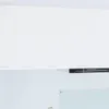 A white kitchen cabinet with a black range hood underneath. Produktbild-Vorschau