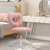 A pink heart-shaped chair in a bedroom setting. Produktbild-Vorschau