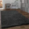A shaggy rug in a living room setting with a record player and shelves of records. Produktbild-Vorschau
