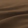 Close-up of dark brown fabric with folds and shadows. Produktbild-Vorschau