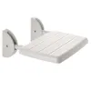 A white folding shower seat mounted on a white wall. Náhled obrázku produktu