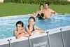 A family is enjoying themselves in an oval-shaped above-ground swimming pool in a backyard setting. Anteprima dell’immagine prodotto