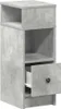A single, tall, narrow nightstand with a concrete-like finish is shown against a white background. It has two open shelves at the top and a drawer that is partially open at the bottom. Náhľad obrázku produktu