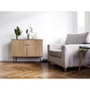 A living room scene with a wooden cabinet and a chair. Produktbild-Vorschau