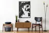 A styled living room corner with a wooden cabinet, artwork, chair, and lamp. Voir les images du produit