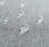 Close-up of water droplets on a gray fabric surface. Voir les images du produit