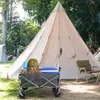 A camping scene with a large tent, a wagon filled with camping gear, and chairs. Produktbild-Vorschau