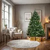 A cozy living room decorated for Christmas, featuring a decorated Christmas tree, armchair, and fireplace. Podgląd zdjęcia produktu