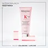 A pink bottle of Kerastase Genesis fondant renforçateur is displayed on a white background, with two pink blocks supporting it. Náhled obrázku produktu