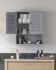 A gray bathroom cabinet filled with various toiletries and cleaning supplies is mounted on a wall above a vanity with a wooden drawer. Náhled obrázku produktu