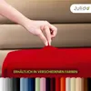 A hand is shown stretching a red fabric, likely a bedsheet or cover, with a row of different colored fabric swatches at the bottom. The brand logo 'Julido' is visible in the top right corner. Produktbild-Vorschau