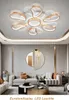 A modern living room with a sofa, coffee table, and a decorative mirror on the wall, under a contemporary ceiling light. Podgląd zdjęcia produktu