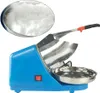 A blue electric ice crusher with a stainless steel bowl and handle, shown with a close-up inset of crushed ice. Náhled obrázku produktu
