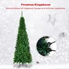 A tall, green artificial Christmas tree with a stand, set against a snowy, blurred background with decorative elements like a star and a small pinecone. Voir les images du produit