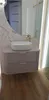 A modern bathroom vanity with a vessel sink and a gold faucet. Voir les images du produit