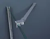 A close-up view of a shower door hinge mechanism made of metal, holding a piece of green glass. Produktbild-Vorschau