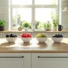 Four bowls of different berries and grapes are arranged on a wooden countertop in front of a window. Podgląd zdjęcia produktu