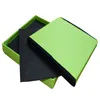 A green storage ottoman is shown with its lid open, revealing black fabric inside. Produktbild-Vorschau
