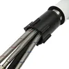 A close-up view of the connection point of a white kitchen faucet, showing the flexible hoses and a black connector. Produktbild-Vorschau