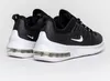 A pair of black and white Nike Air Max Axis sneakers shown from the back. Voir les images du produit