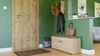 An entryway with a wooden door, shoe cabinet, coat rack, and accessories. Náhľad obrázku produktu
