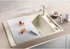 A kitchen sink with a cutting board, fruit, and a knife. Podgląd zdjęcia produktu
