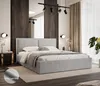 A modern bedroom with a light gray upholstered bed as the focal point. Voir les images du produit